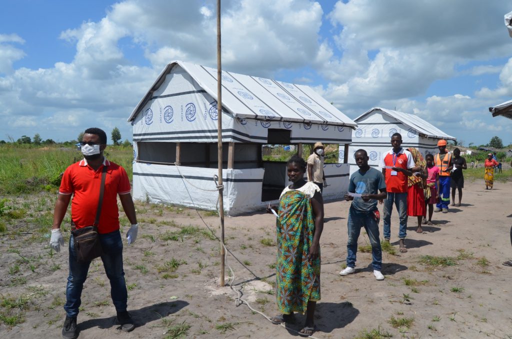 Mozambique: Recipients of food assistance are divided into smaller groups and asked to stay 1.5 metres apart. Photo: WFP/Rafael Campos